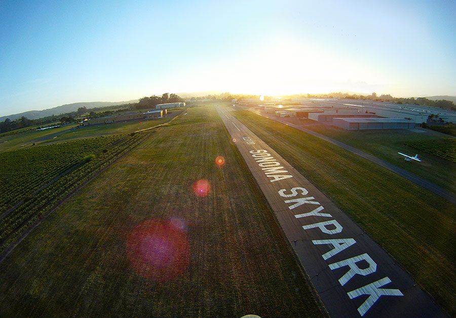 view of the noses of a long row of vintage airplanes